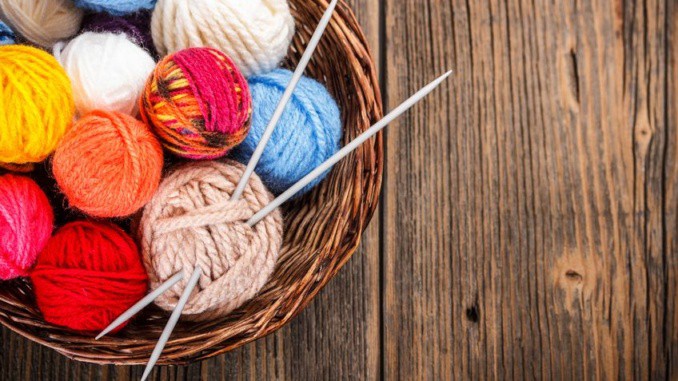 Balls of yarn in a basket with knitting needles balls of yarn in a basket with knitting needles